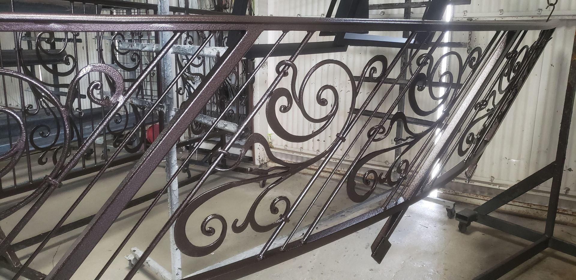 A wrought iron railing is sitting on a table in a room.