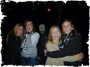 A group of people posing for a picture with one wearing a mask