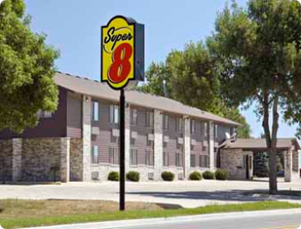 A super 8 hotel with a sign in front of it.