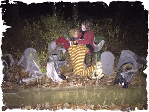 A couple of children sitting on a bench in a cemetery