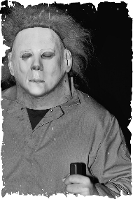 A black and white photo of a man wearing a mask
