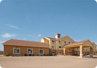 A large building with a lot of windows and a blue sky in the background.