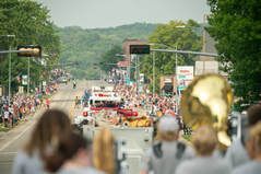 A marching band is marching down a street in a parade.