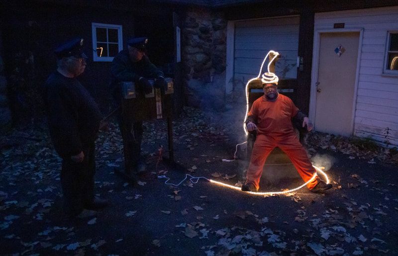 A man is standing in a circle with a light behind him.