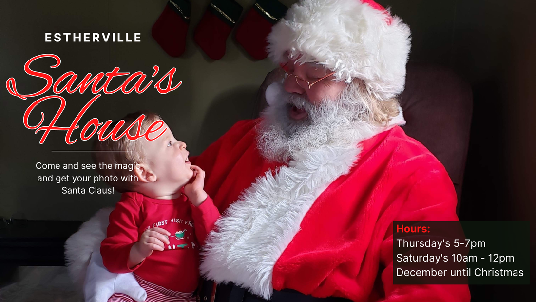 A man in a santa suit is holding a baby in his arms.