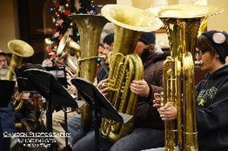 A group of people are playing brass instruments in a band.