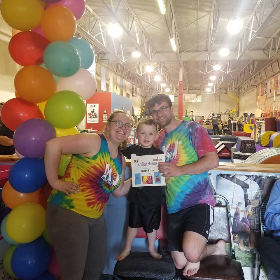A group of people posing for a picture with balloons in the background