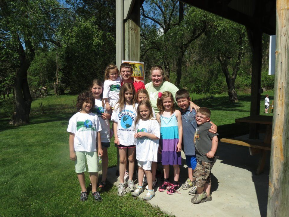 A group of children posing for a picture in a park