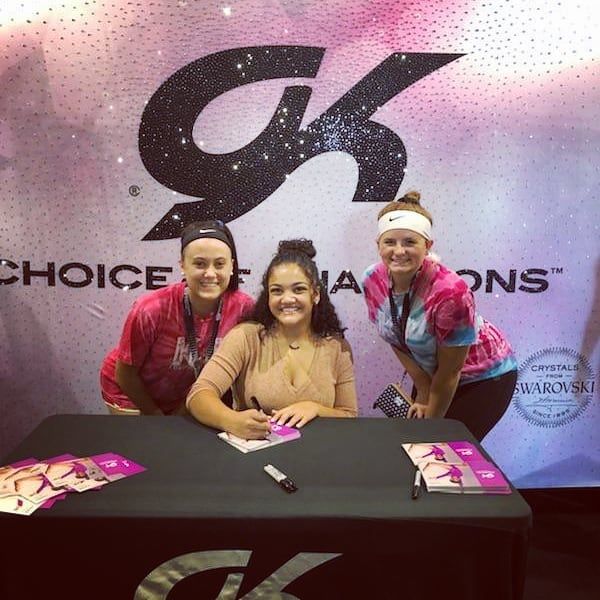Three women are posing for a picture in front of a choice champions sign