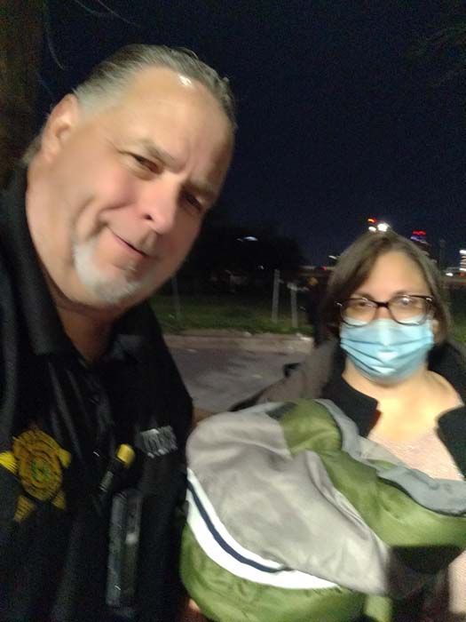 A man and a woman wearing face masks are posing for a picture