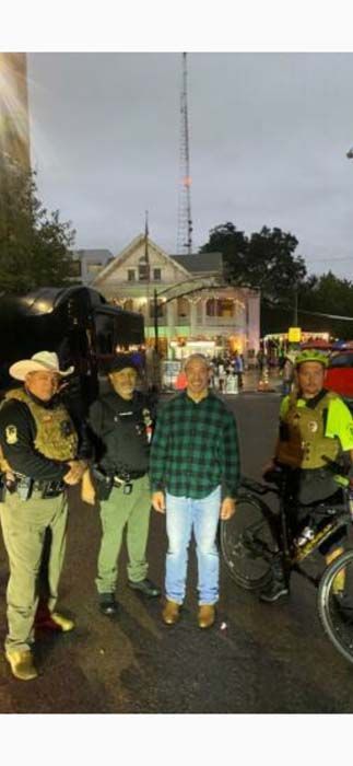 A group of men are standing next to each other in front of a building.