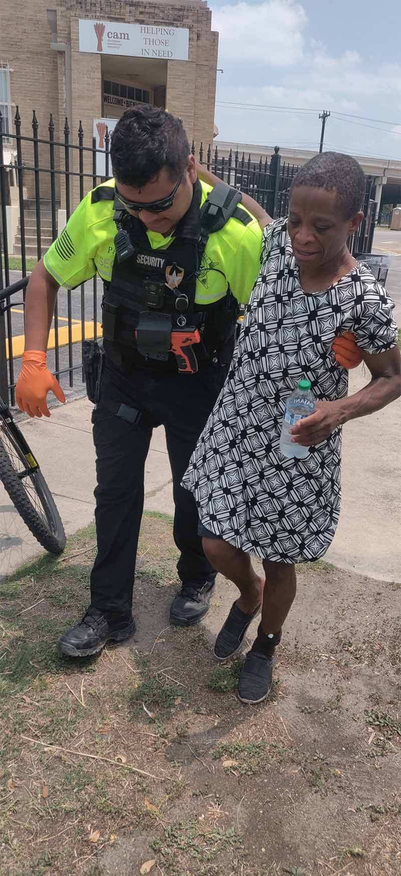 A police officer is helping a young girl walk down the street.