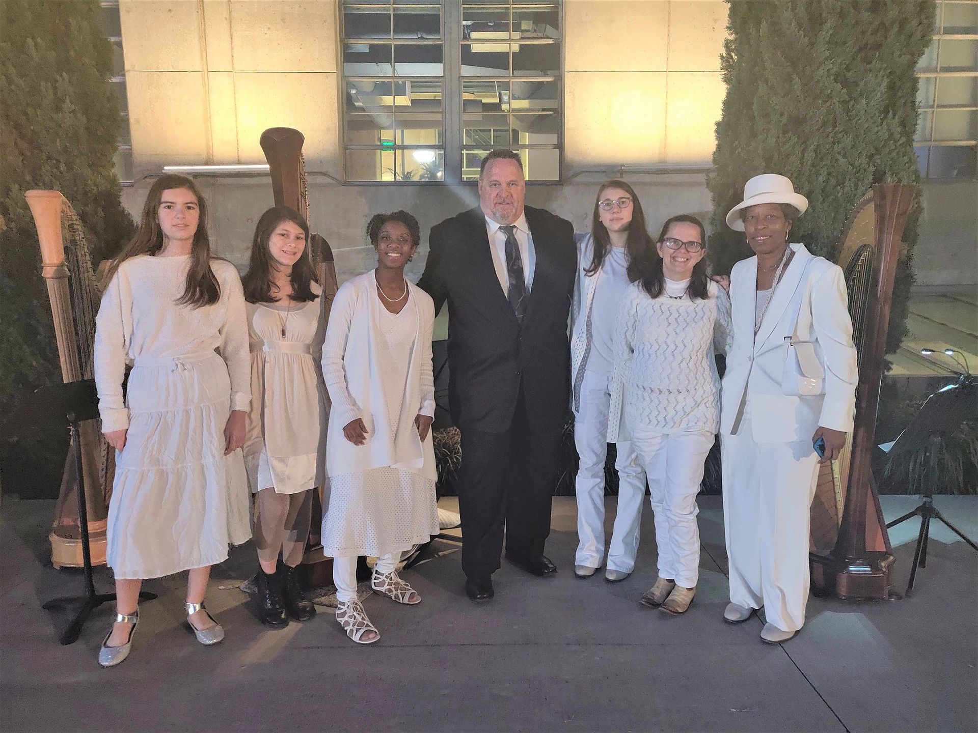 A group of people in white standing next to each other