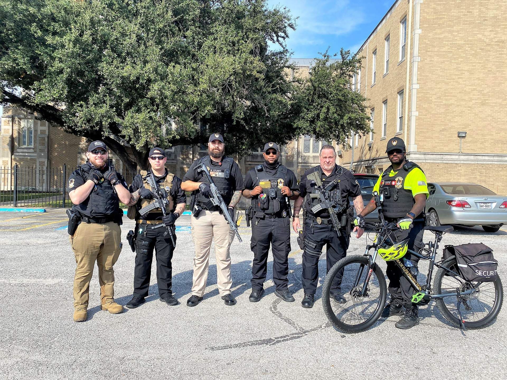 A group of police officers are posing for a picture with a bicycle.