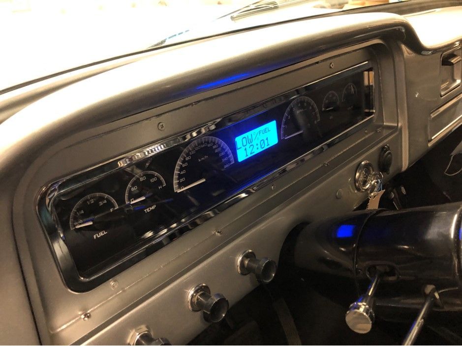 A close up of a car dashboard with a digital display