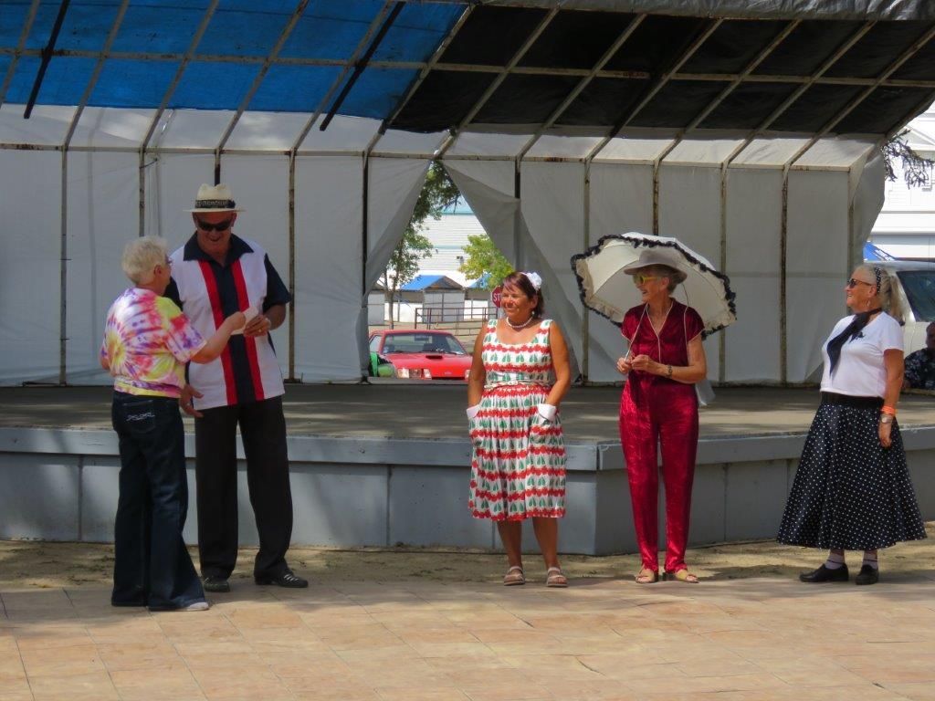 A group of people are standing in front of a stage.