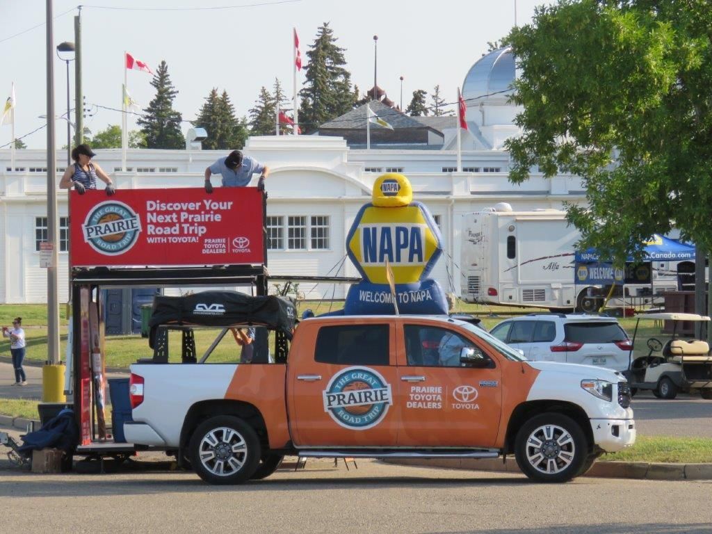A napa truck is parked in front of a building