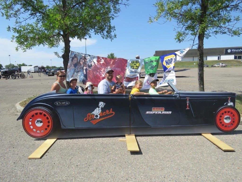 A group of people are sitting in a car that says napa on the side