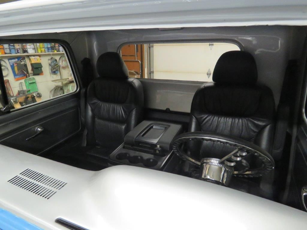 The inside of a car with black seats and a steering wheel