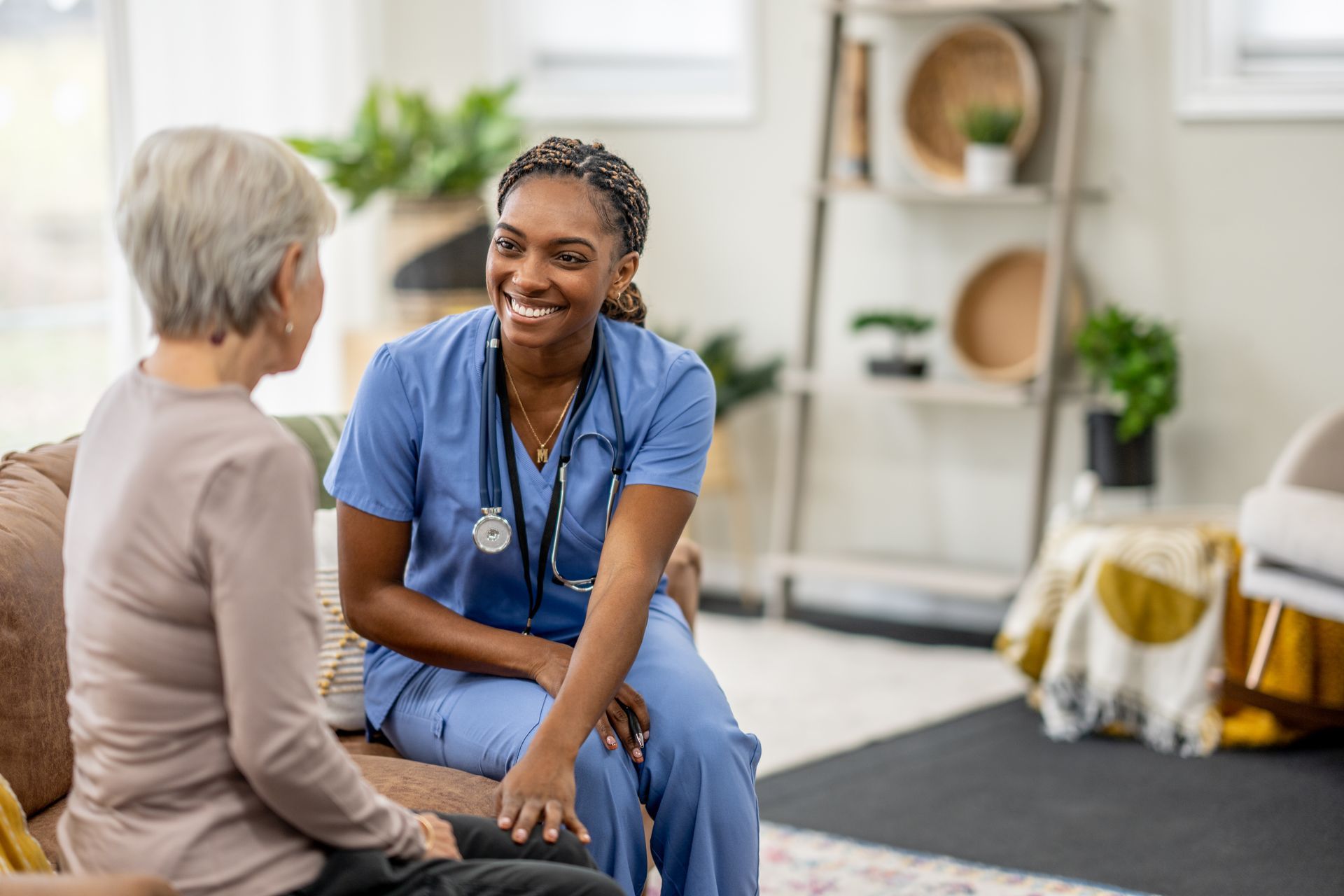 Group of diverse medical professionals smiling, wearing white coats, scrubs, and stethoscopes.