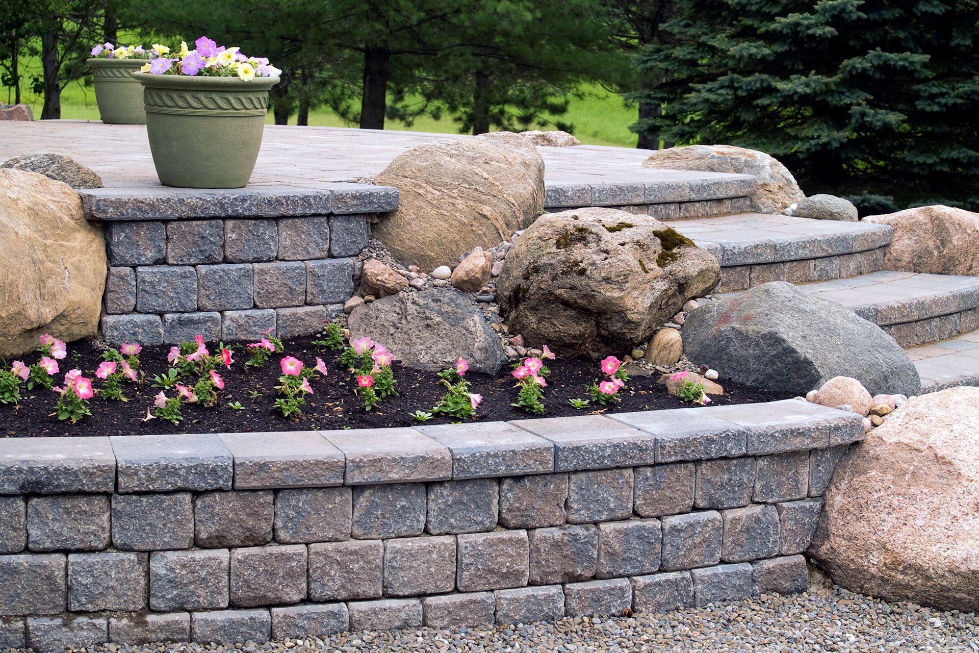 a stone wall with flowers and rocks on it