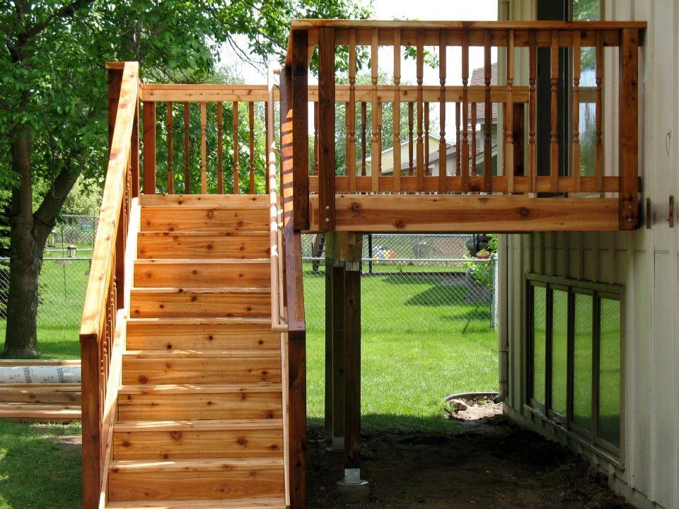 A wooden deck with stairs leading up to it
