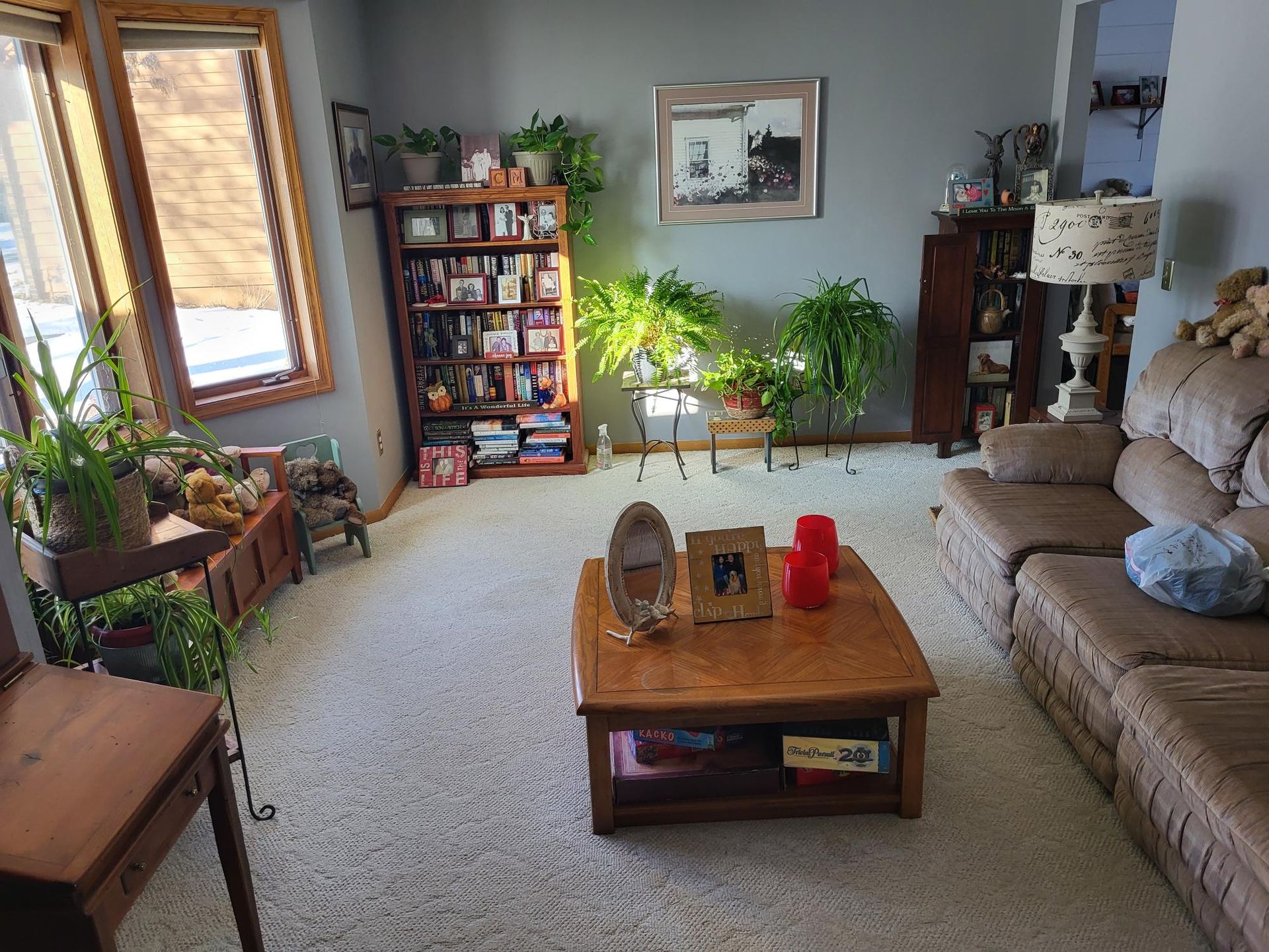 A hole in a textured white ceiling exposing a vertical pipe, with a recessed light fixture visible nearby.