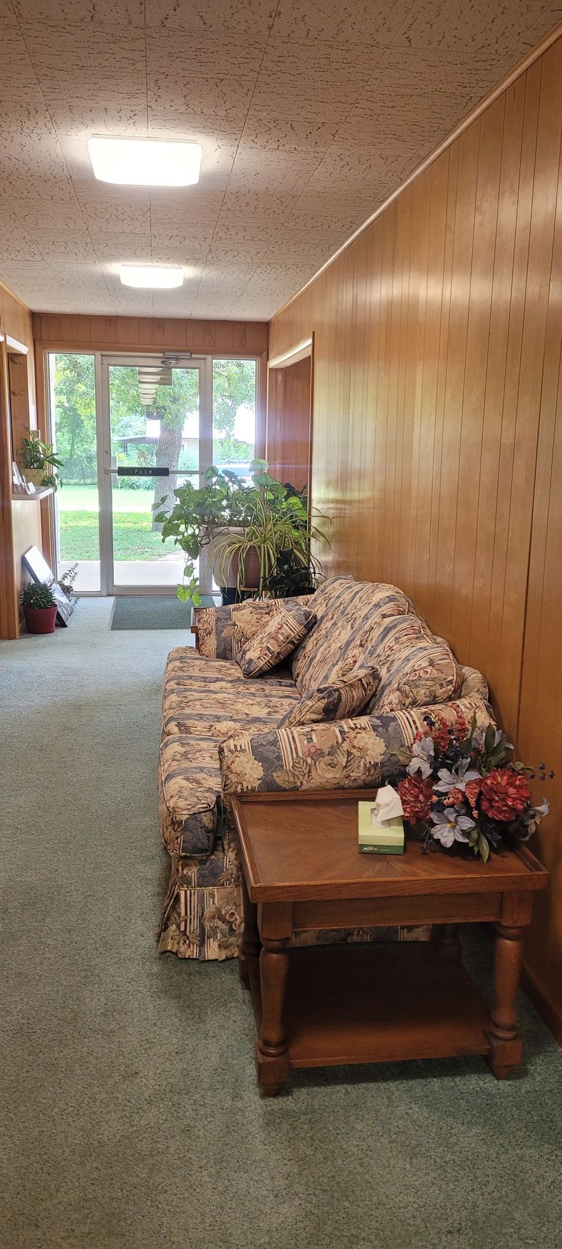 A living room with a couch , table , and window.