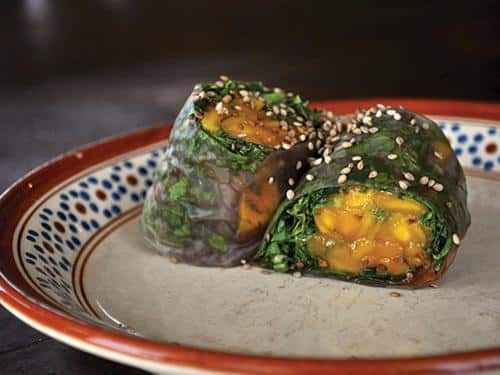 A close up of a plate of food with two rolls on it.