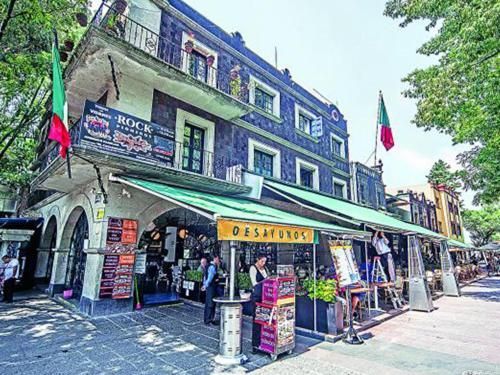 A large building with a green awning on the side of it.