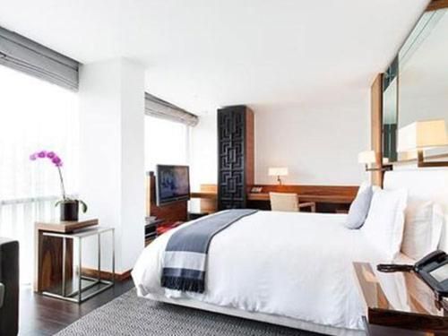 A hotel room with a large bed and a television