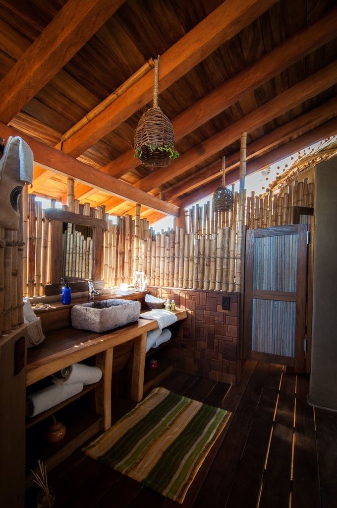 A bathroom with a wooden ceiling and a sink
