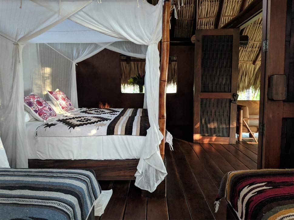 A bedroom with a canopy bed and two beds