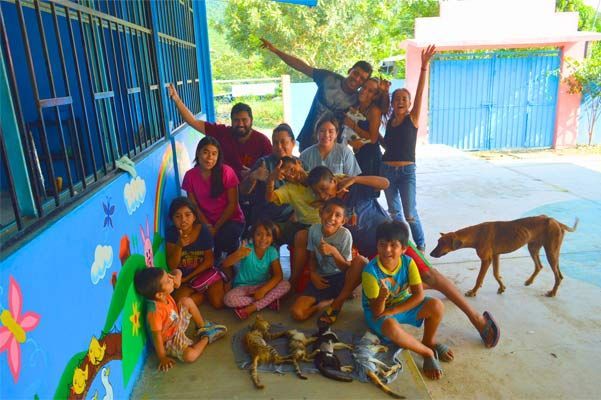 A group of children and a dog pose for a picture