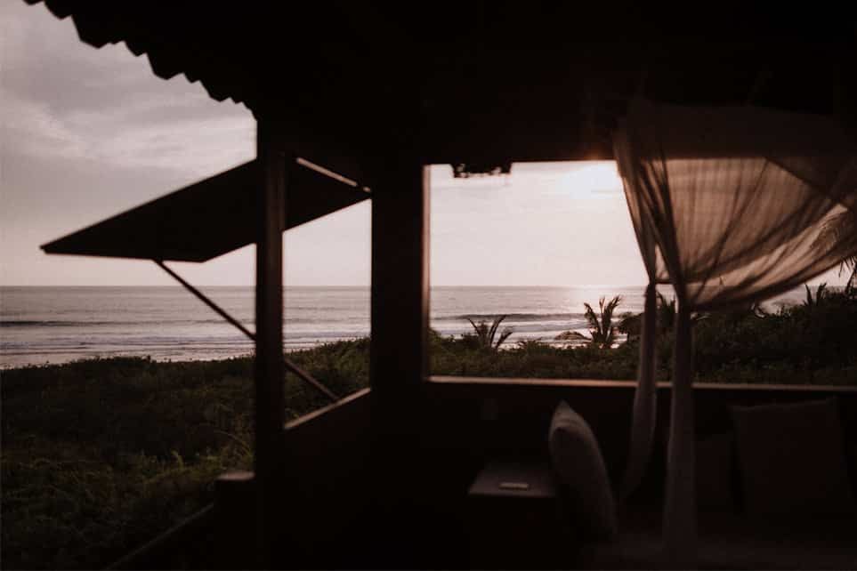 A view of the ocean from a gazebo with a canopy