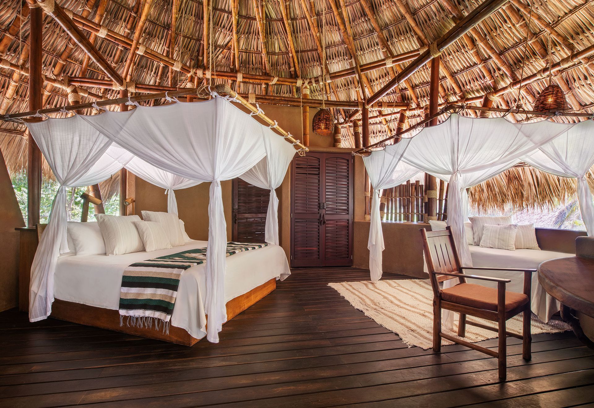 There is a canopy bed in the middle of the room.