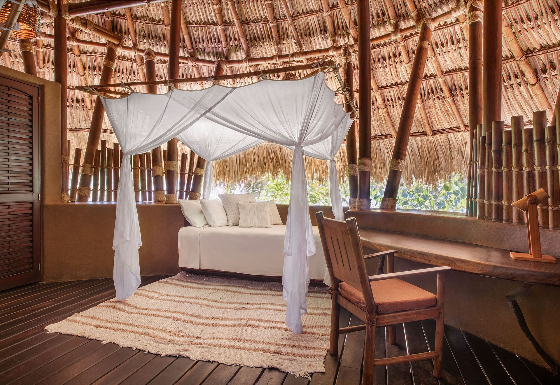 There is a canopy bed in the middle of the room.