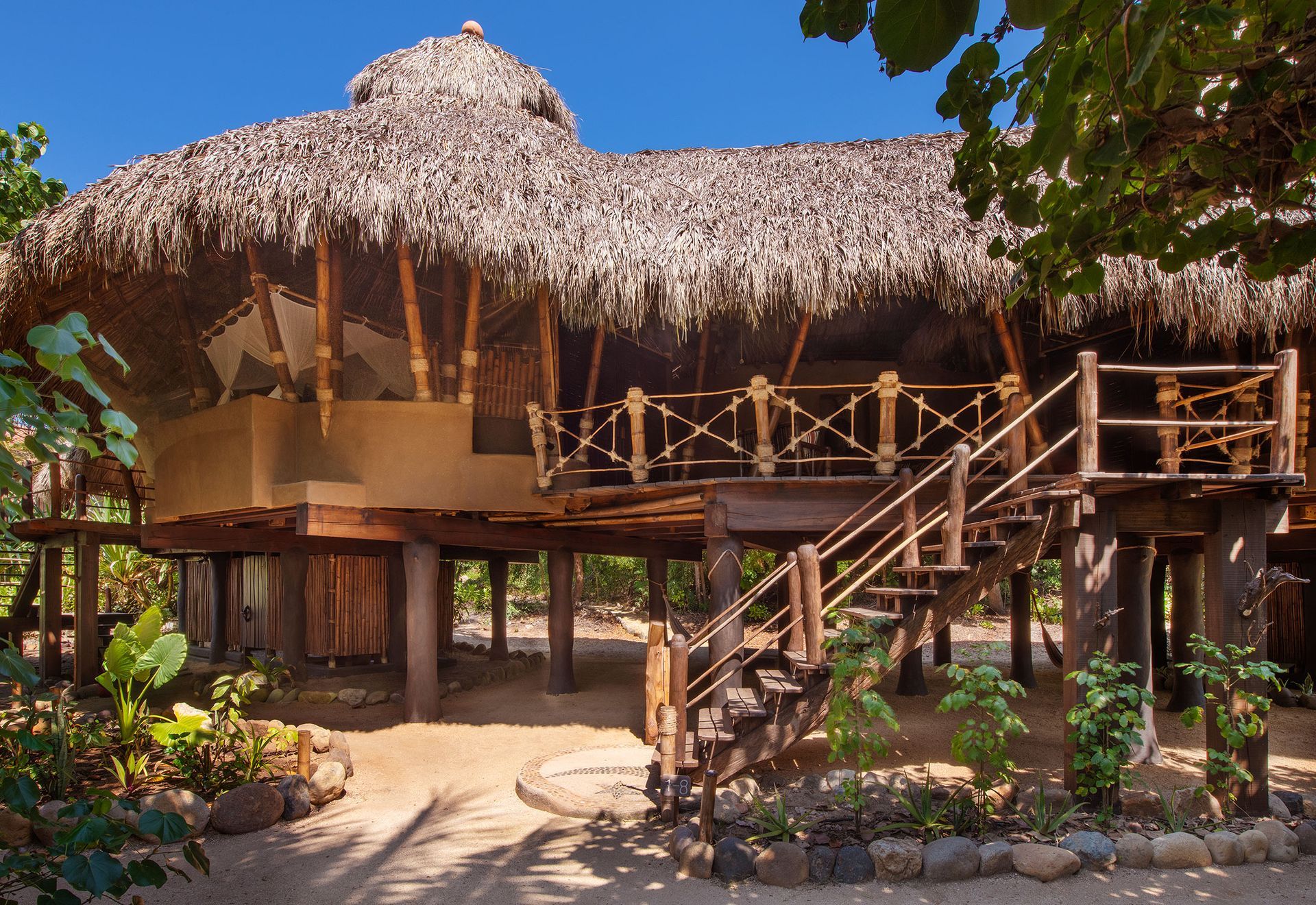 A thatched hut with stairs leading up to it
