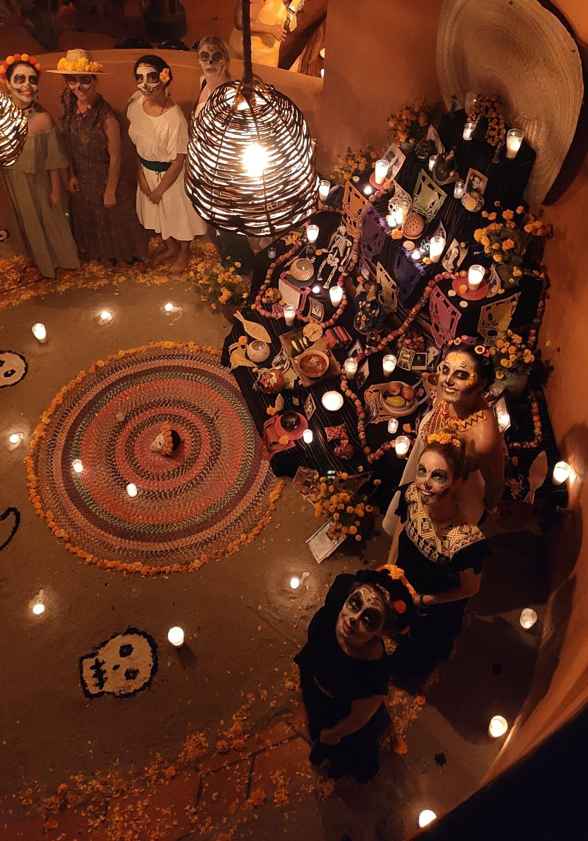 A group of people standing around a circle of candles