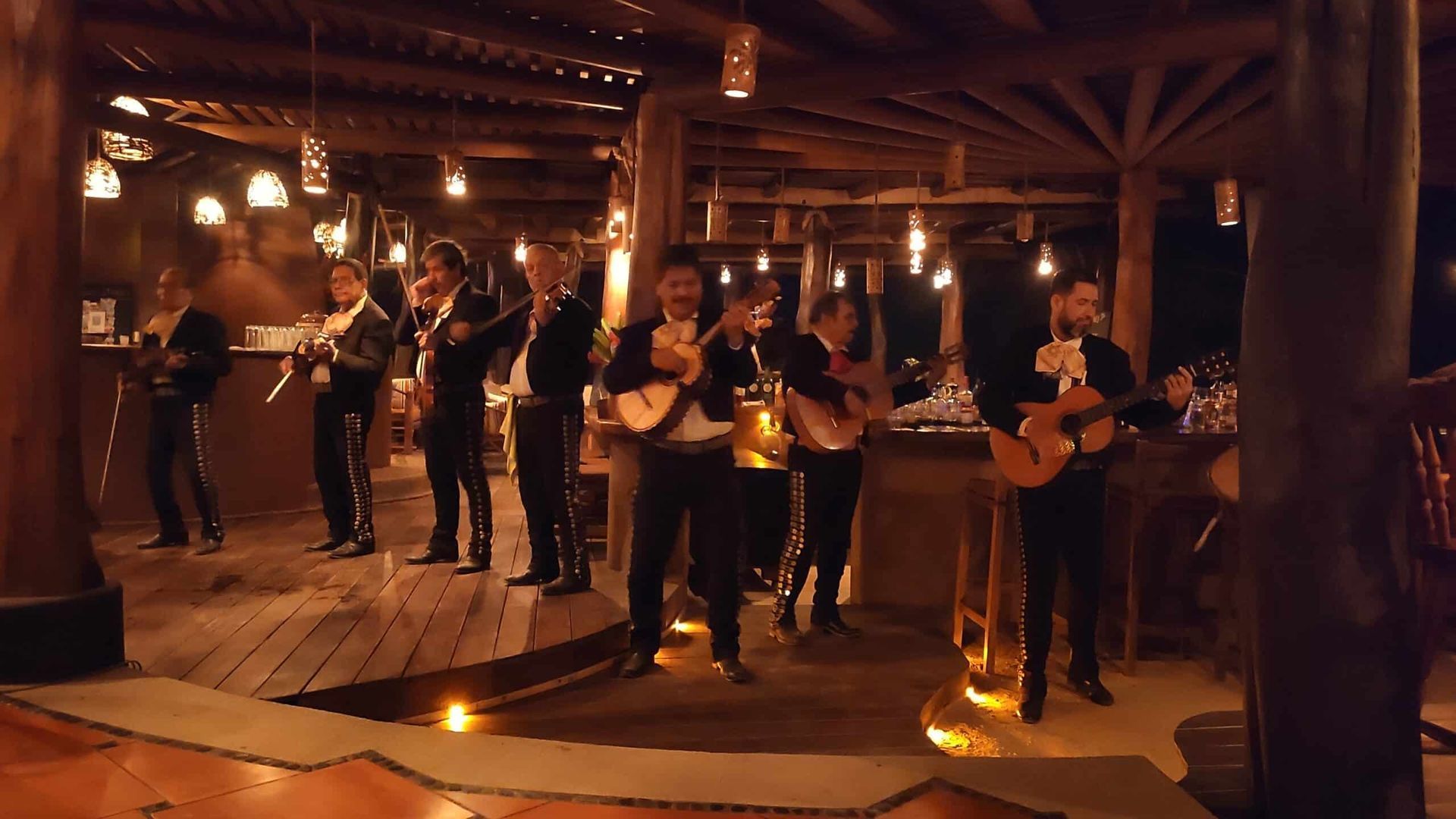 A group of men are playing guitars in a room.