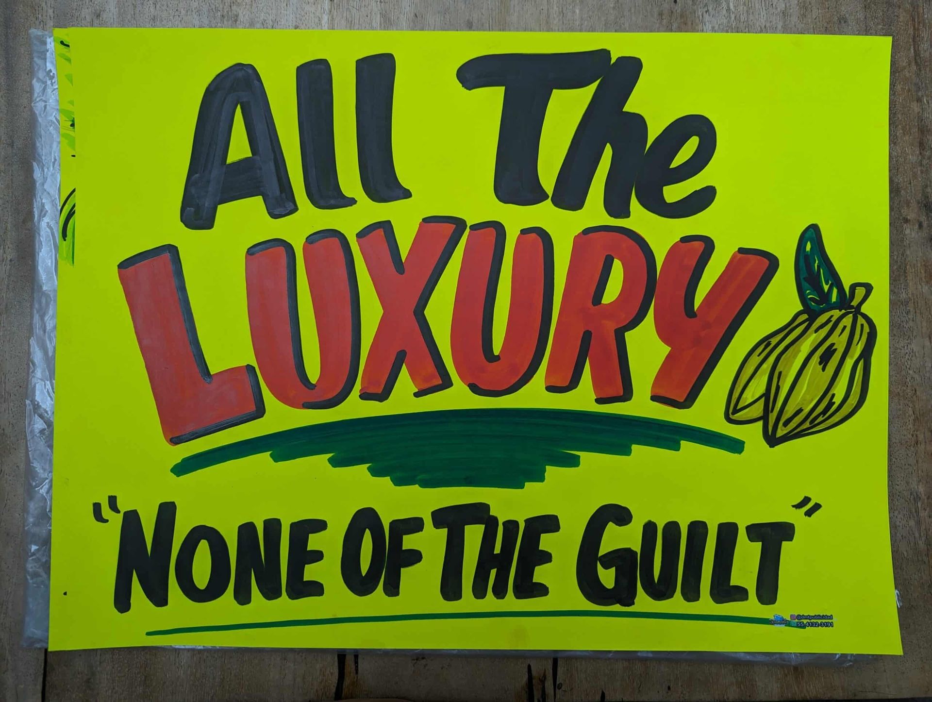 A yellow sign that says all the luxury none of the guilt
