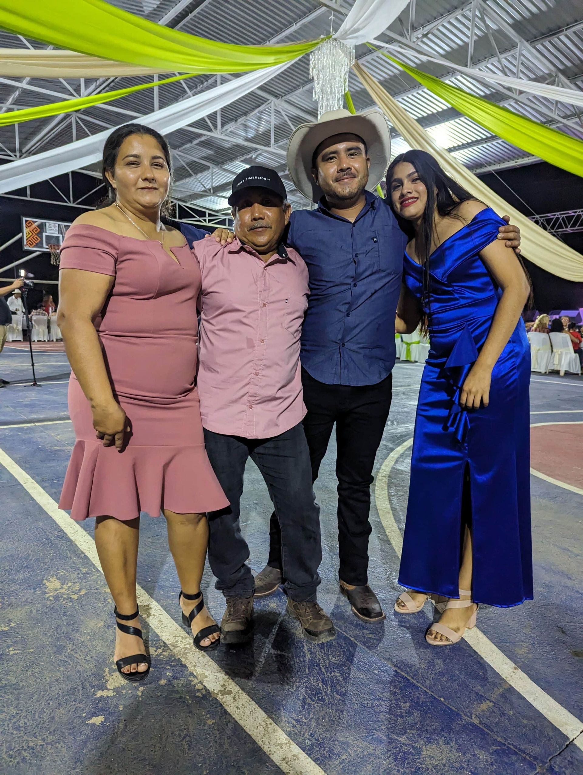 A group of people are posing for a picture in a gym.
