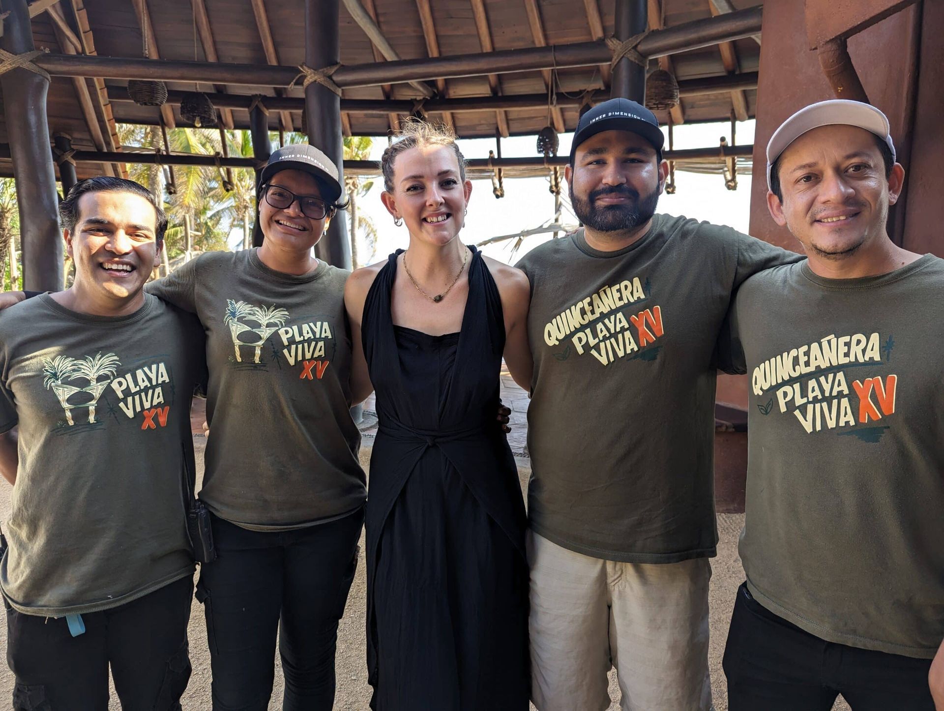 A group of people posing for a picture with one wearing a shirt that says playa viva