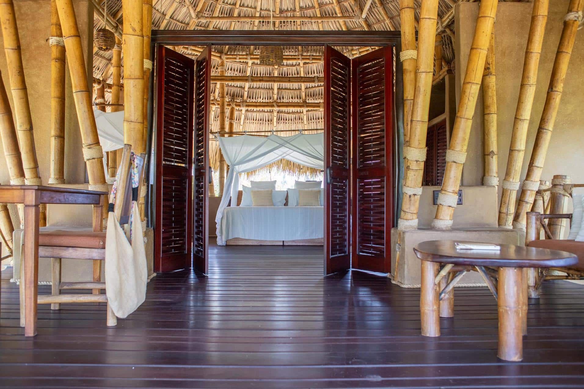 A living room with a wooden floor and bamboo walls.