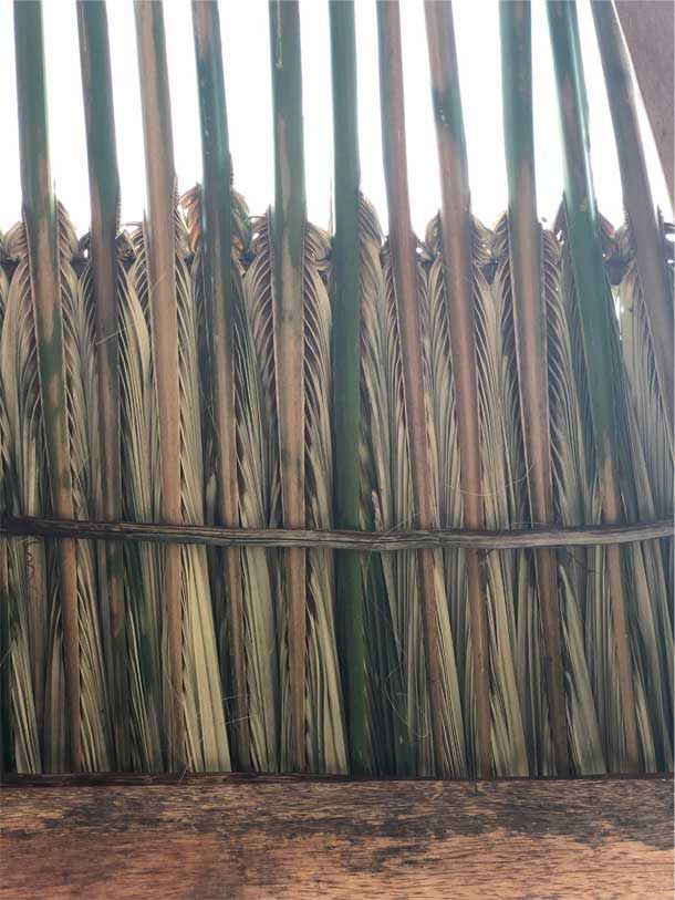 A bunch of brooms sitting on top of a wooden table.