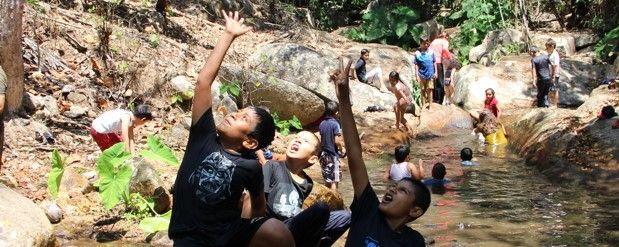 A group of people are playing in a river.