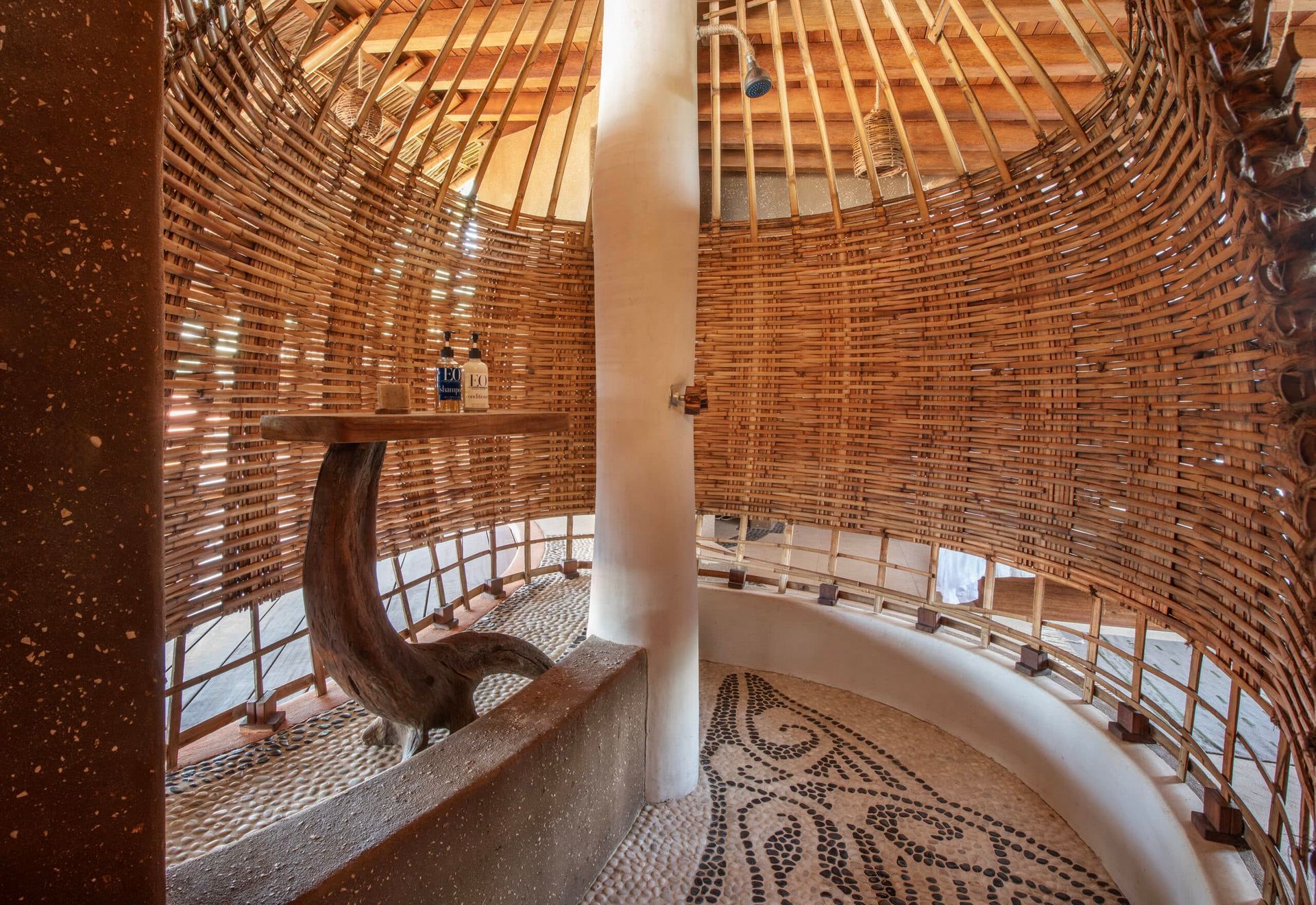 A bathroom with a wicker wall and a dolphin on the wall