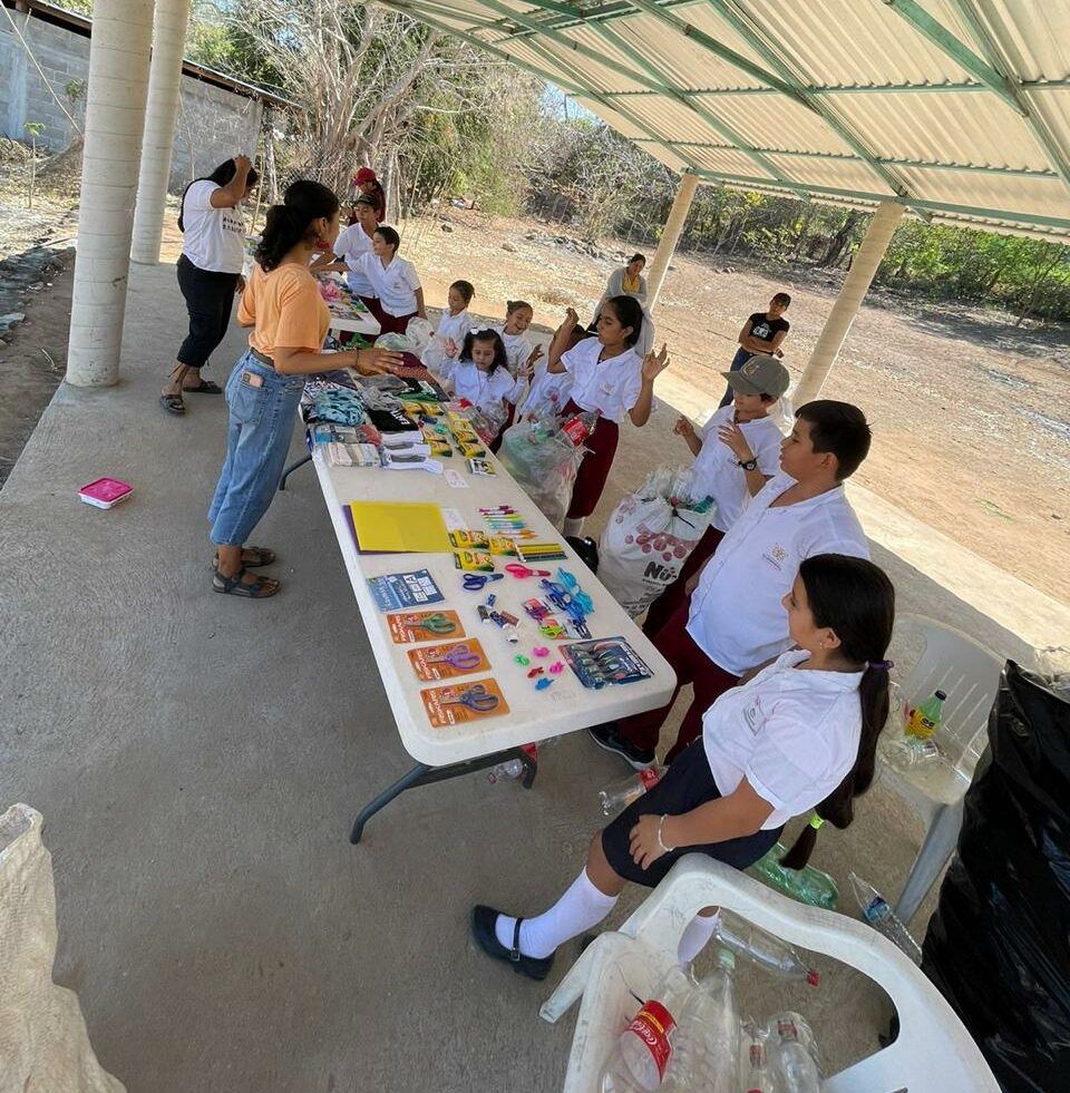 A group of people are gathered around a table with toys on it