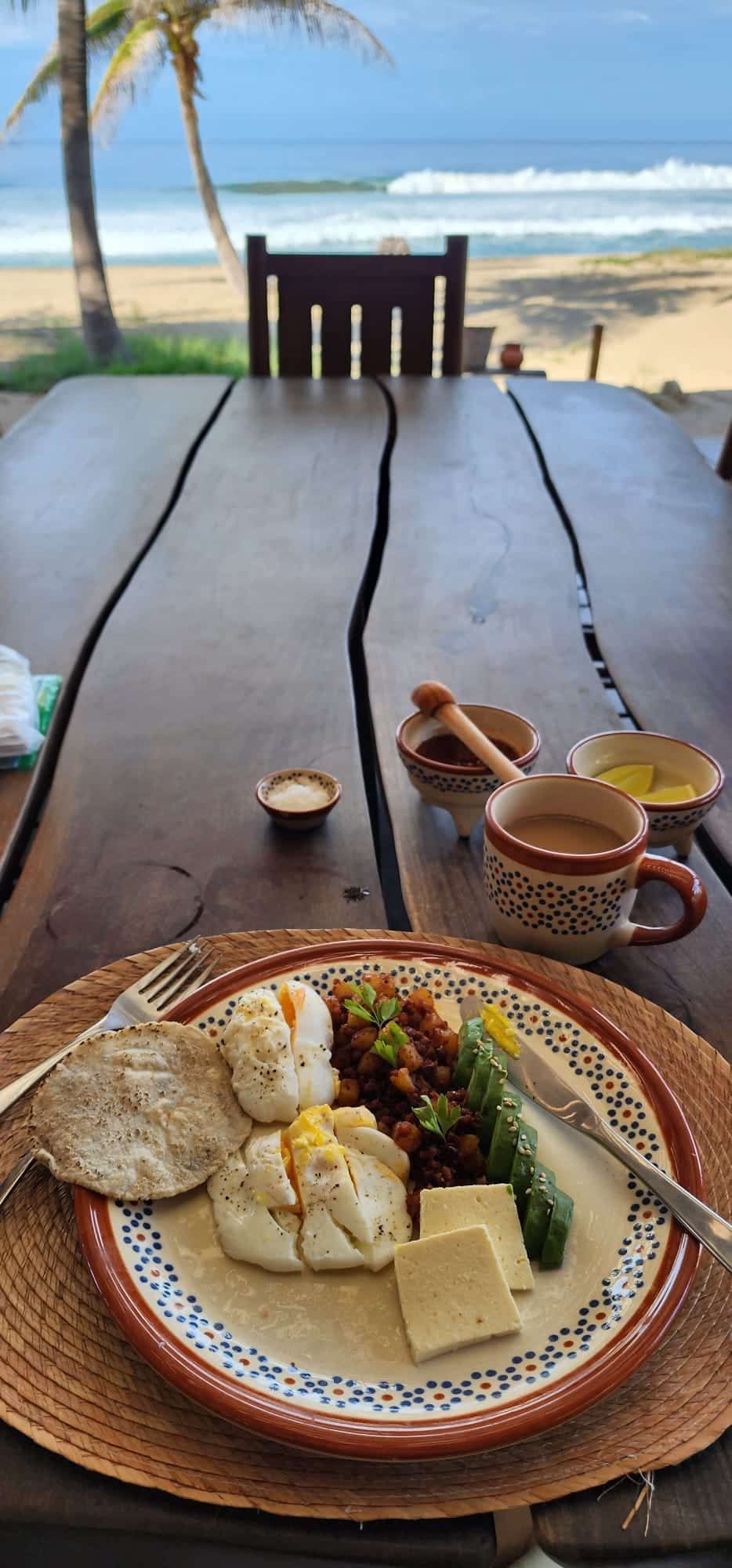 A plate of food is sitting on a wooden table.