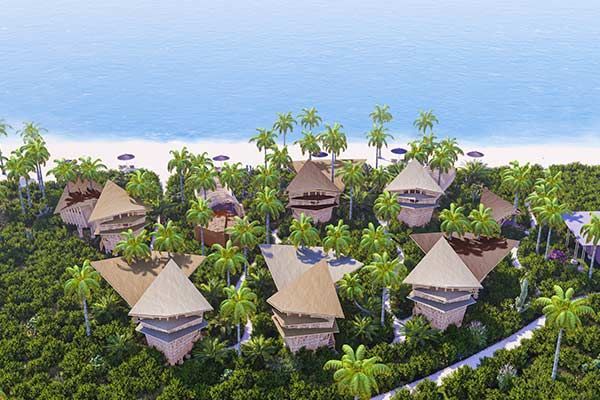 An aerial view of a tropical resort with thatched huts and palm trees